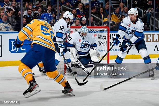 Jansen Harkins Brenden Dillon and Connor Hellebuyck of the Winnipeg Jets defend the net against Noel Acciari of the St. Louis Blues at the Enterprise...