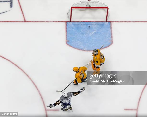 Nicholas Paul of the Tampa Bay Lightning celebrates a goal against goalie Juuse Saros and Jeremy Lauzon of the Nashville Predators during the third...