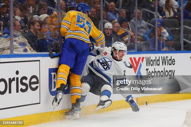 Colton Parayko of the St. Louis Blues chess Michael Eyssimont of the Winnipeg Jets in the second period at Enterprise Center on December 8, 2022 in...