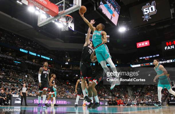 Keldon Johnson of the San Antonio Spurs drives for two against Alperen Sengun of the Houston Rockets in the first half at AT&T Center on December 8,...