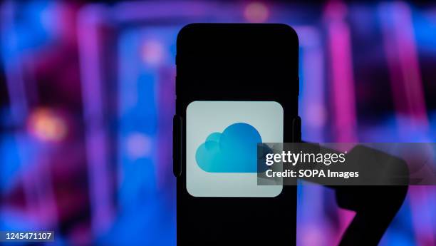 In this photo illustration, the logo of iCloud app is seen displayed on a mobile phone screen.