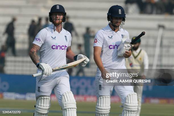 England's captain Ben Stokes and teammate Will Jacks walk back to the pavilion during a break for Friday prayers, on the first day of the second...