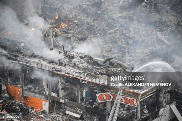 Russia firefighters battle a massive blaze the size of a football pitch which broke out overnight at the Mega Khimki shopping and entertainment...