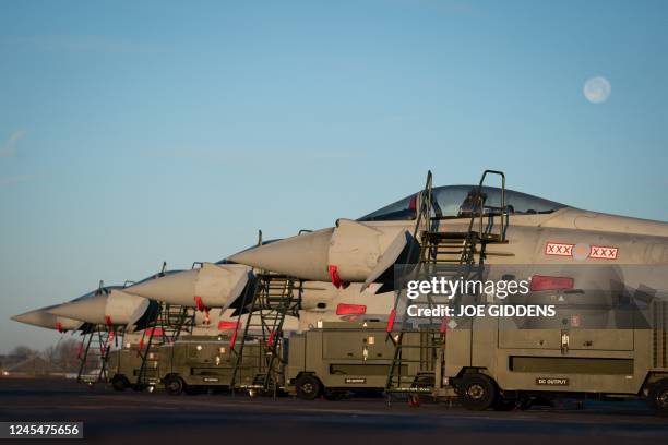 Typhoon fighter jets are pictured at Royal Air Force base RAF Coningsby, near Lincoln, eastern England, on December 9 during a visit by Britain's...