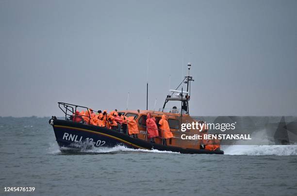 Migrants, picked up at sea attempting to cross the English Channel from France, are brought ashore on a Royal National Lifeboat Institution lifeboat...