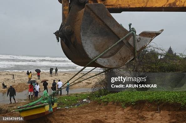 An excavator pulls a fishing boat to save area in Mahabalipuram on ...