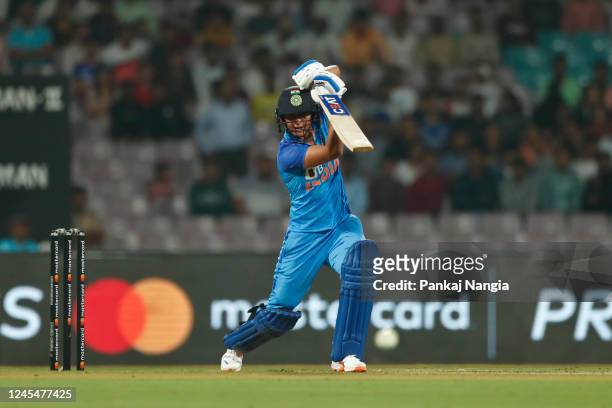 Harmanpreet Kaur of India plays a shot during the T20 International series between India and Australia at Dr DY Patil Cricket Stadium on December 9,...