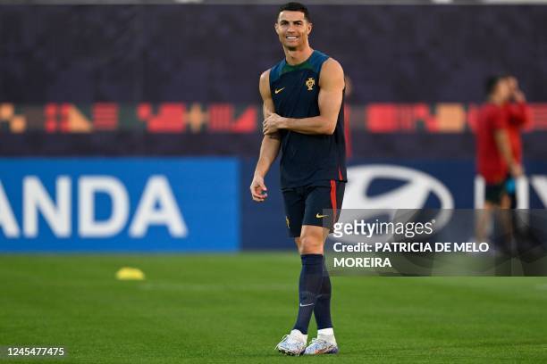 Portugal's forward Cristiano Ronaldo takes part in a training session at the Al Shahaniya SC training site, northwest of Doha on December 9 on the...