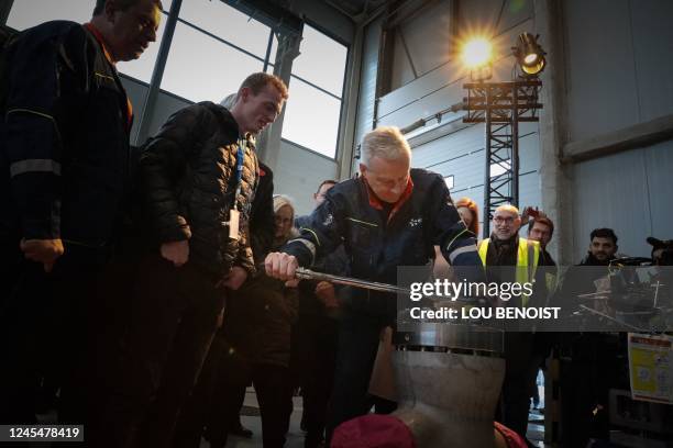 French Minister for the Economy and Finances Bruno Le Maire adjusts a bolt with a ratchet as he visits the Penly Nuclear Power Plant in Petit-Caux,...