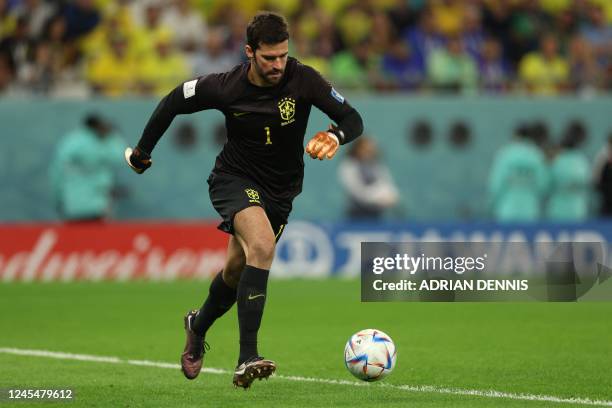 Brazil's goalkeeper Alisson preapres to shoot the ball during the Qatar 2022 World Cup quarter-final football match between Croatia and Brazil at...