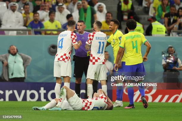 Croatia's midfielder Ivan Perisic and Croatia's midfielder Marcelo Brozovic argue with English referee Michael Oliver after Brazil's defender Danilo...