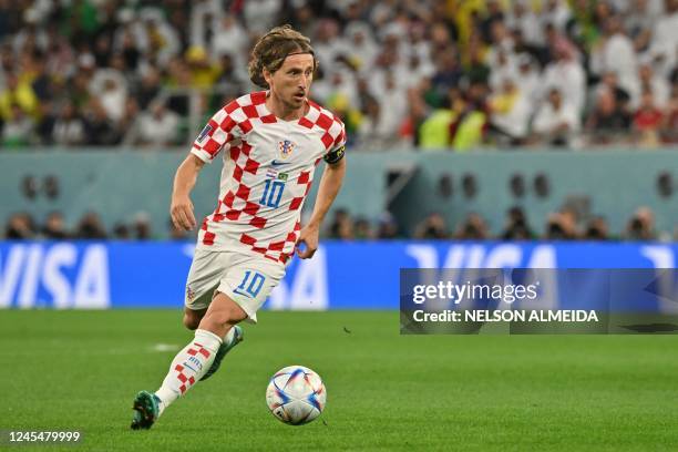 Croatia's midfielder Luka Modric runs with the ball during the Qatar 2022 World Cup quarter-final football match between Croatia and Brazil at...
