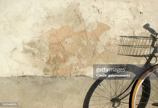 bicycle by damaged wall - mottled stock pictures, royalty-free photos & images