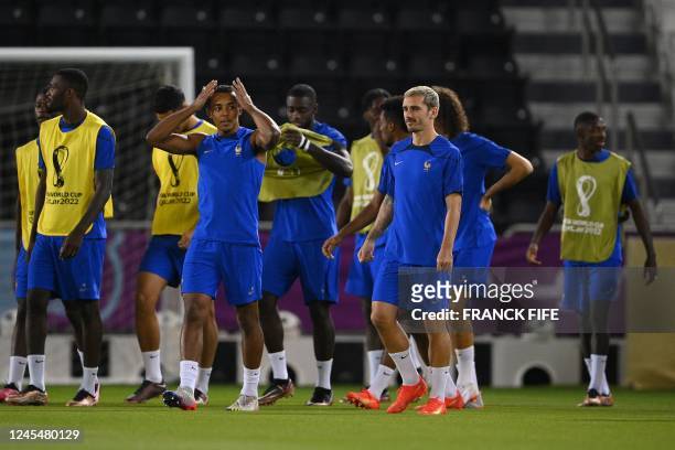 France's players including France's forward Antoine Griezmann and France's defender Jules Kounde take part in a training session at Al Sadd SC...