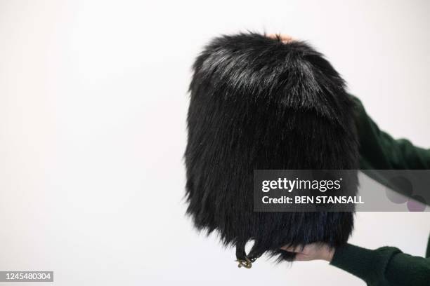 Peta's Senior campaign manager, Kate Werner, poses with a faux fur bearskin hat, produced by French company Ecopel, in London on November 23, 2022....