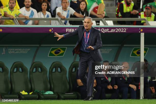 Brazil's coach Tite shouts instructions to his players from the touchline during the Qatar 2022 World Cup quarter-final football match between...