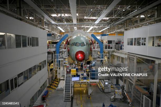 An employee works at the Airbus A350 assembly site, in Colomiers near Toulouse, south-western France, on December 9, 2022.