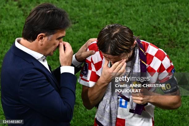 Croatia's coach Zlatko Dalic talks to Croatia's midfielder Luka Modric before the start of extra-time during the Qatar 2022 World Cup quarter-final...