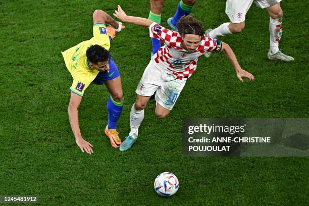 Brazil's midfielder Lucas Paqueta and Croatia's midfielder Luka Modric fight for the ball during the Qatar 2022 World Cup quarter-final football...