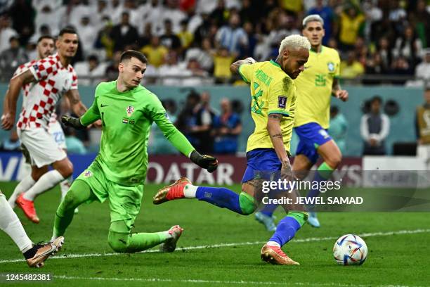 Brazil's forward Neymar eludes Croatia's goalkeeper Dominik Livakovic to score his team's first goal during the Qatar 2022 World Cup quarter-final...