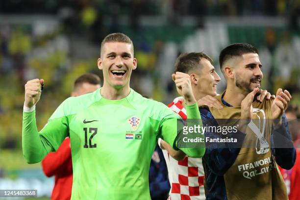Ivo Grbic of Croatia celebrates victory in a penalty shootout with team-mates during the FIFA World Cup Qatar 2022 quarter final match between...