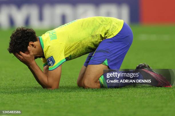 Brazil's defender Marquinhos reacts after he failed to score the last shot in the penalty shoot-out during the Qatar 2022 World Cup quarter-final...