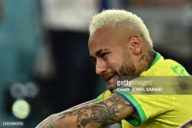 Brazil's forward Neymar cries after losing in the penalty shoot-out after extra-time of the Qatar 2022 World Cup quarter-final football match between...
