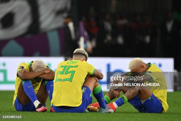 Brazil's forward Rodrygo, Brazil's forward Pedro and Brazil's forward Neymar react after Brazil lost in the penalty shoot-out the Qatar 2022 World...