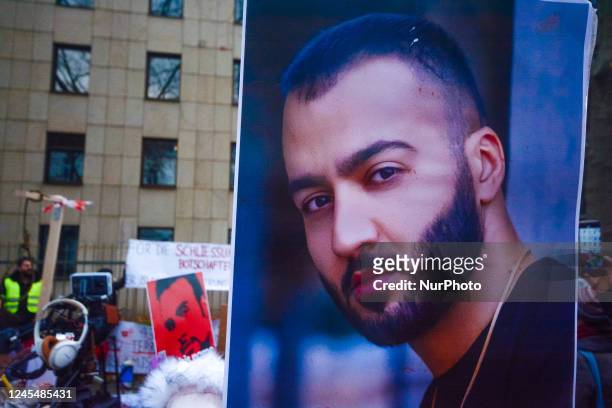 Activists hold pictures of the man who was executed by Iranian regime on Thursday during the freedom of Iran protest in front of federal foreign...