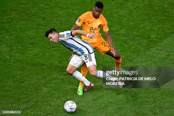 Argentina's defender Marcos Acuna fights for the ball with Netherlands' defender Denzel Dumfries during the Qatar 2022 World Cup quarter-final...