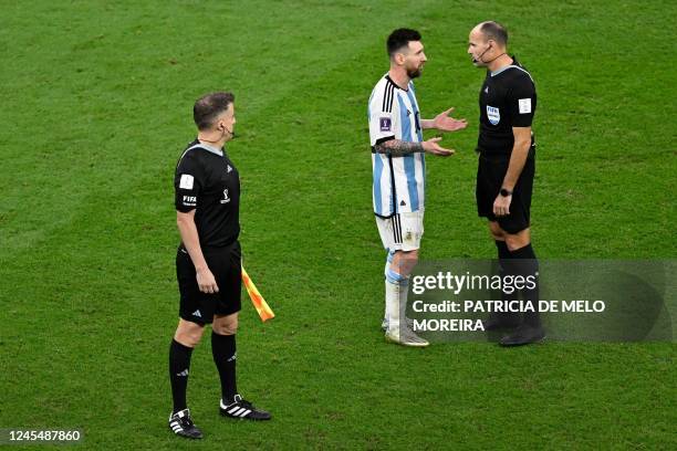 Argentina's forward Lionel Messi argues with Spanish referee Antonio Mateu during the Qatar 2022 World Cup quarter-final football match between The...