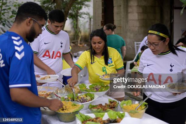 Relatives of Brazil's forward Richarlison have lunch at the house of Sebastiana Francisca, the player's grandmother, before watching the Qatar 2022...