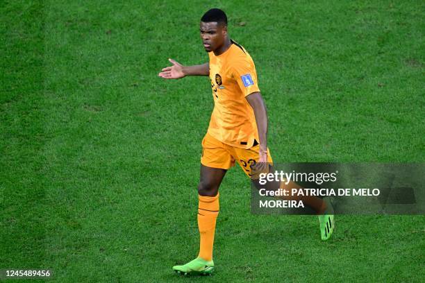 Netherlands' defender Denzel Dumfries reacts during the Qatar 2022 World Cup quarter-final football match between The Netherlands and Argentina at...