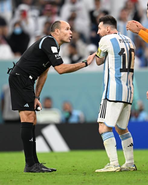 Messi and referee talk during the FIFA World Cup Qatar 2022 quarter final match between Netherlands and Argentina held at Lusail Stadium on December...