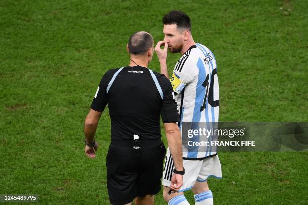 Argentina's forward Lionel Messi argues with Spanish referee Antonio Mateu during the Qatar 2022 World Cup quarter-final football match between The...