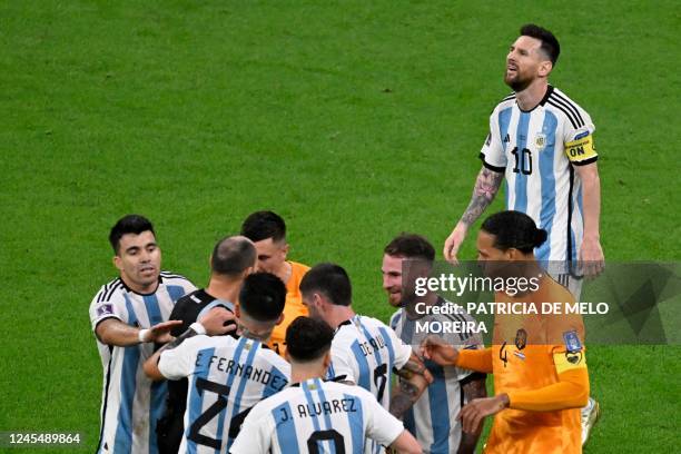Netherlands players argue with Spanish referee Antonio Mateu after he called for a penalty during the Qatar 2022 World Cup quarter-final football...