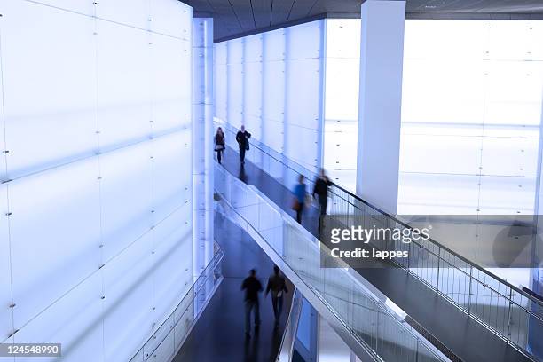 people walking in different direction in commercial building - abstract architecture and people stock pictures, royalty-free photos & images