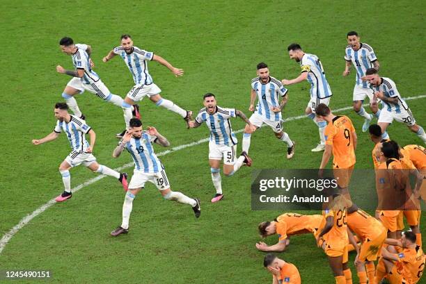 Argentina players celebrate after winning penalties in the FIFA World Cup Qatar 2022 quarter final match between Netherlands and Argentina held at...