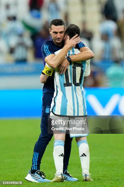 Lionel Scaloni head coach of Argentina and Lionel Messi right winger of Argentina and Paris Saint-Germain celebrate victory after the FIFA World Cup...