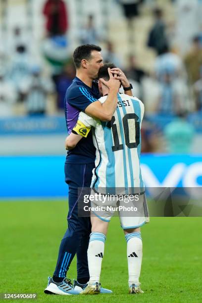 Lionel Scaloni head coach of Argentina and Lionel Messi right winger of Argentina and Paris Saint-Germain celebrate victory after the FIFA World Cup...