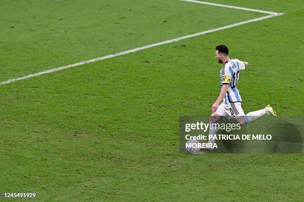 Argentina's forward Lionel Messi scores a goal from the penalty spot during the Qatar 2022 World Cup quarter-final football match between The...