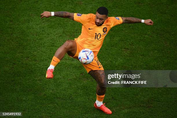 Netherlands' forward Memphis Depay controls the ball during the Qatar 2022 World Cup quarter-final football match between The Netherlands and...