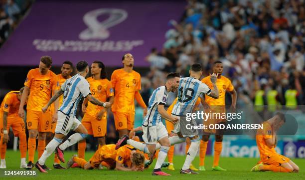 Argentina's players celebrate their win in the Qatar 2022 World Cup quarter-final football match between The Netherlands and Argentina at Lusail...