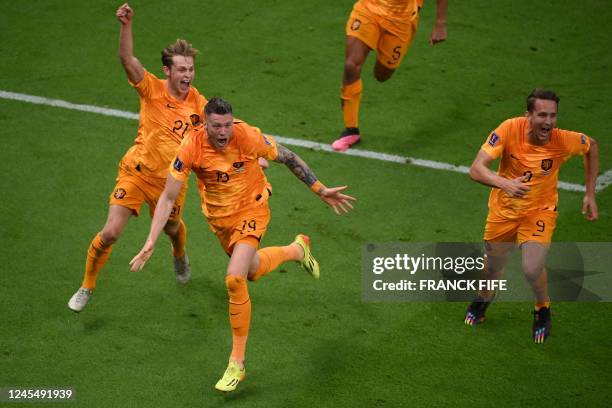 Netherlands' forward Wout Weghorst celebrates with Netherlands' midfielder Frenkie De Jong and Netherlands' forward Luuk De Jong after he scored his...