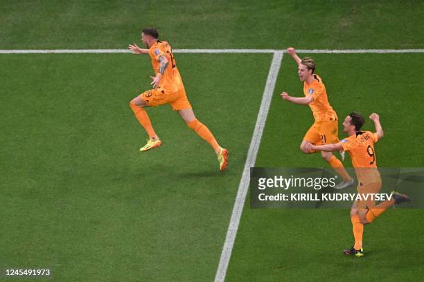 Netherlands' forward Wout Weghorst celebrates with Netherlands' midfielder Frenkie De Jong and Netherlands' forward Luuk De Jong after he scored his...
