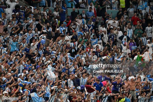 Argentina supporters celebrate their team's victory during the Qatar 2022 World Cup quarter-final football match between The Netherlands and...