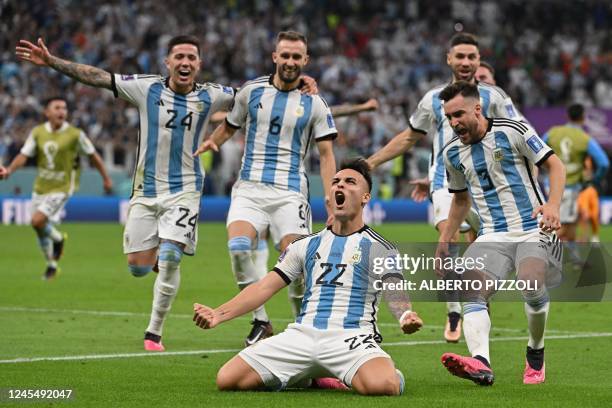 Argentina's forward Lautaro Martinez celebrates after scoring his penalty and qualifying to the next round after defeating Netherlands in the penalty...