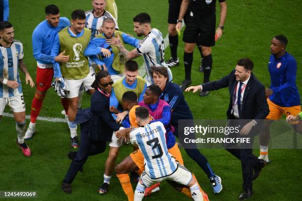 Former Netherlands players Edgar Davids intervenes as Netherlands and Argentina players clash during the Qatar 2022 World Cup quarter-final football...
