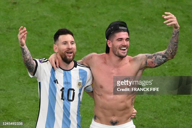 Argentina's forward Lionel Messi and Argentina's midfielder Rodrigo De Paul celebrate after they won the Qatar 2022 World Cup quarter-final football...