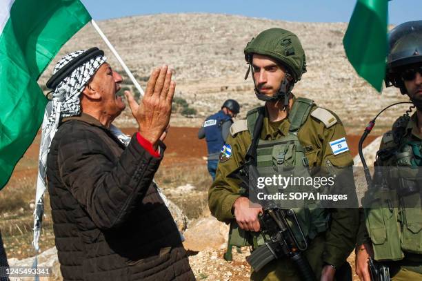Palestinian protesters seen arguing with the Israeli soldiers during the demonstration against Israeli settlements in the village of Beit Dajan near...